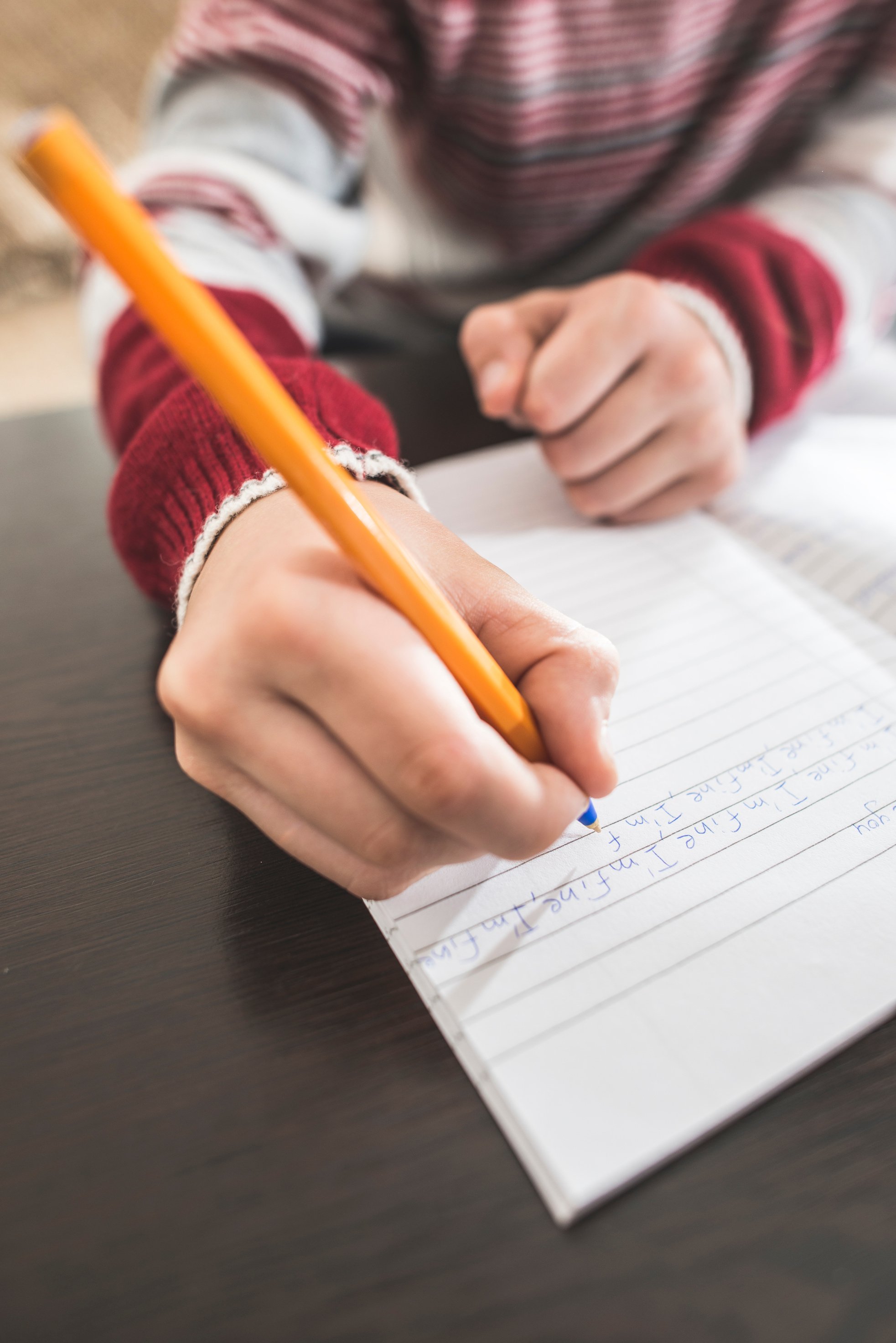 Child Write in a Notebook.